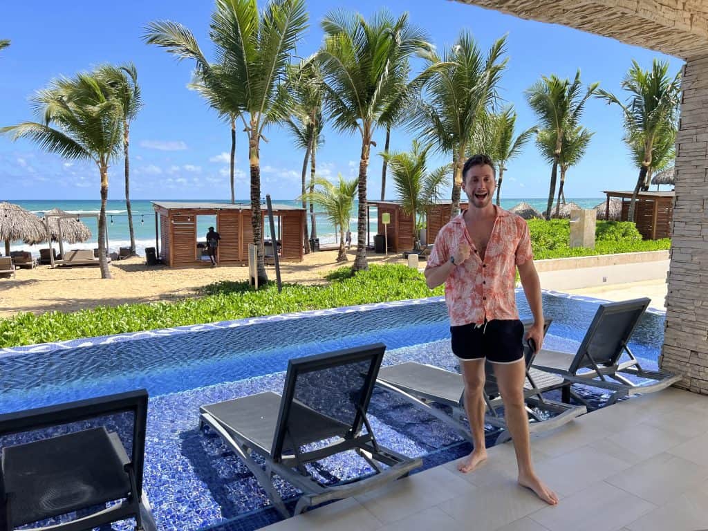 Beautiful beach view with palm trees and ocean in the background at a tropical resort.