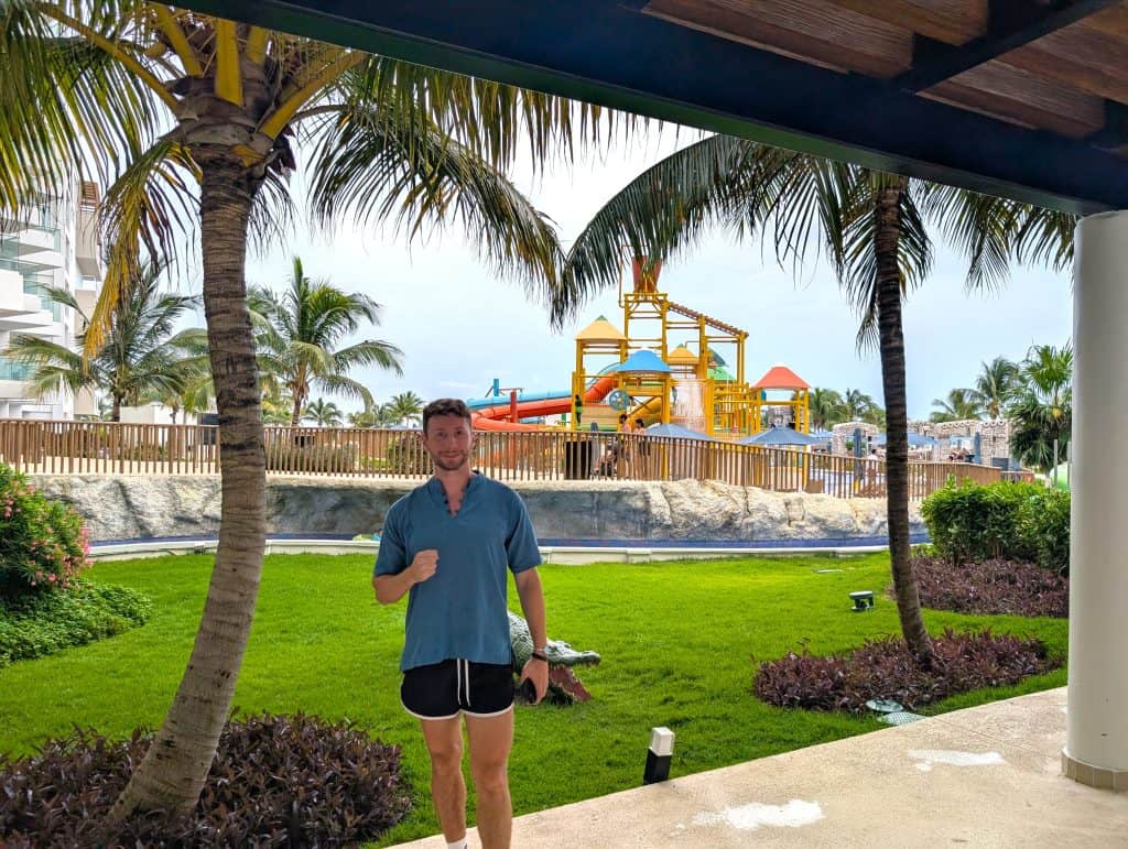 Colorful water park slides and lush tropical landscaping at a resort.