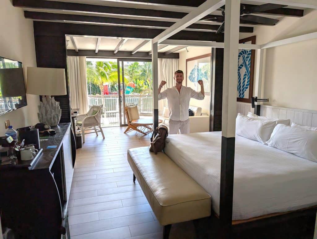 Cozy hotel room with balcony and tropical surroundings, bright interior with modern decor.