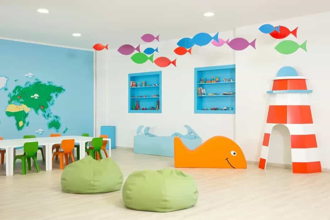 A colorful children's playroom with fish-themed decor and seating area.