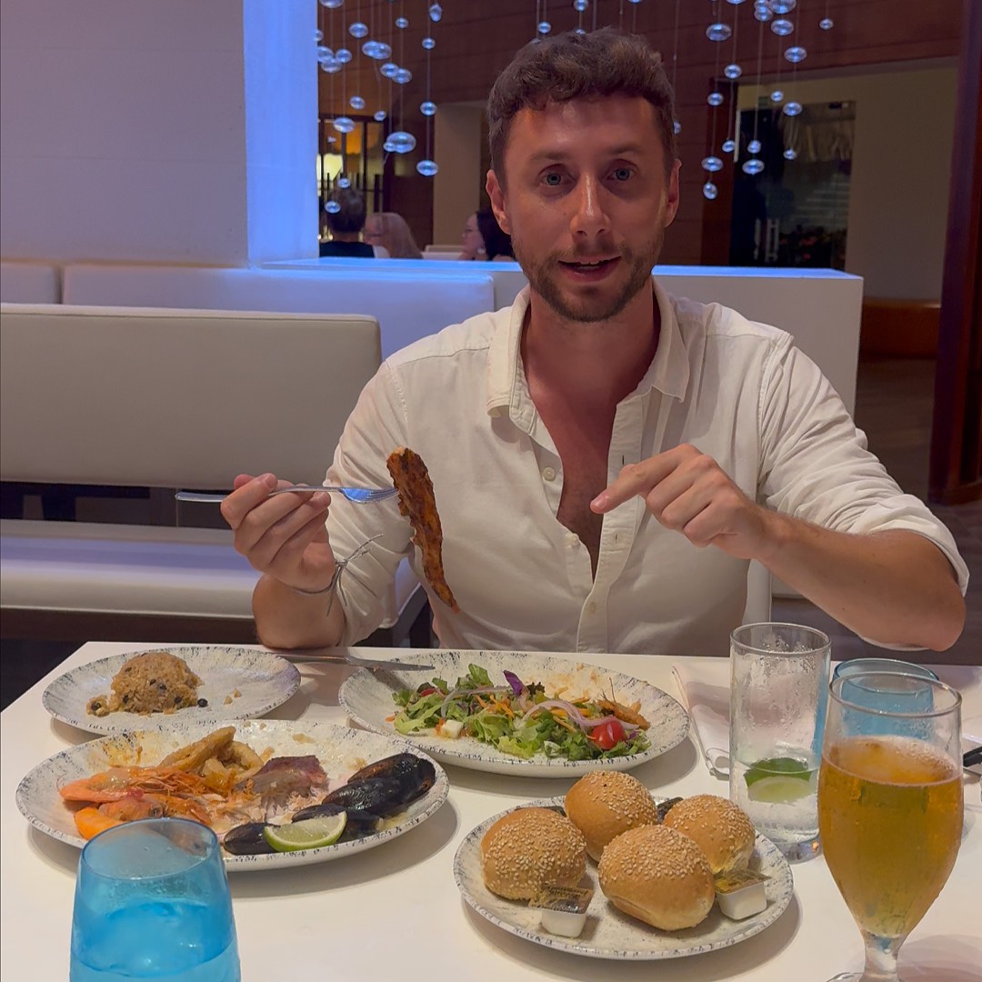 Javier testing seafood at a Punta Cana resort restaurant