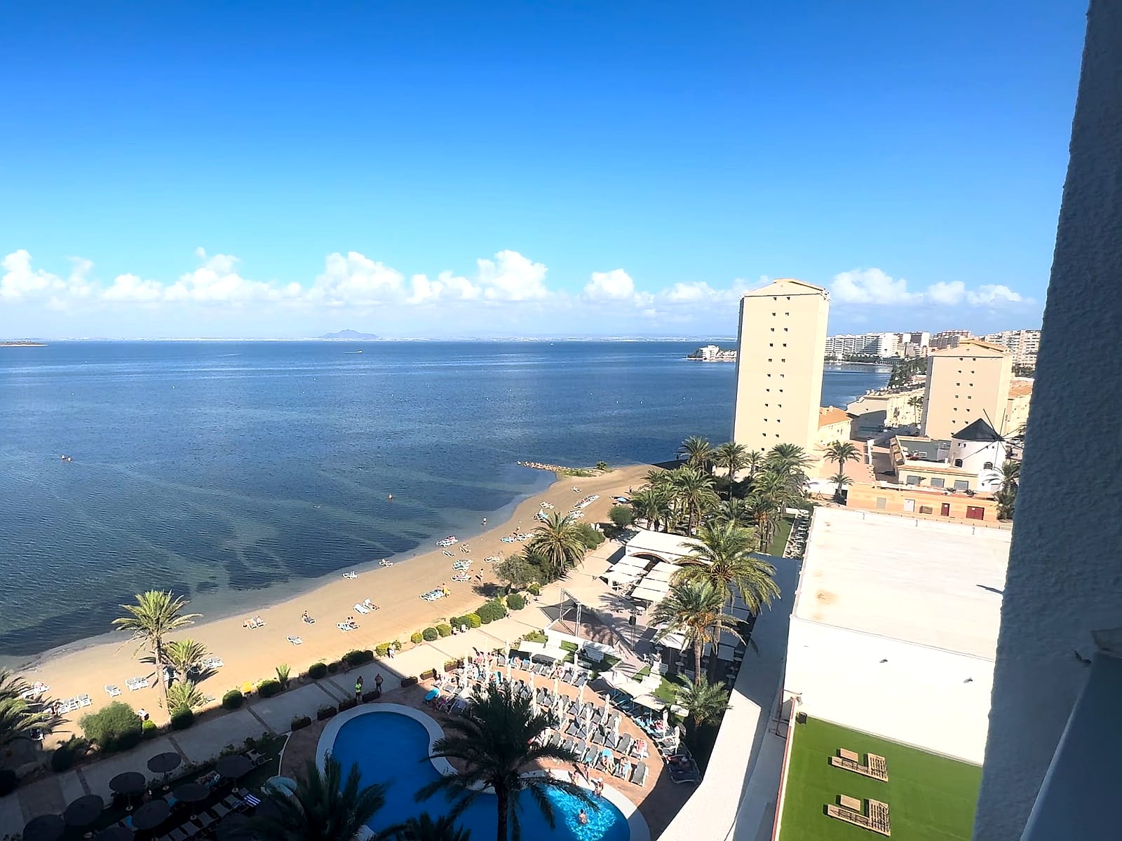 Vista desde una planta alta del AluaSun Doblemar: la playa del Mar Menor, las piscinas y La Manga