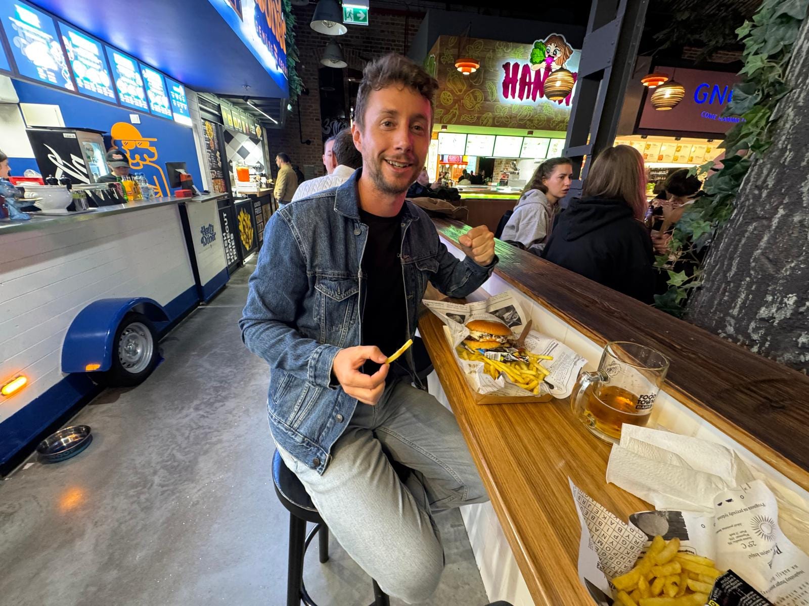 Javier cenando una hamburguesa en un mercado de comida de Varsovia