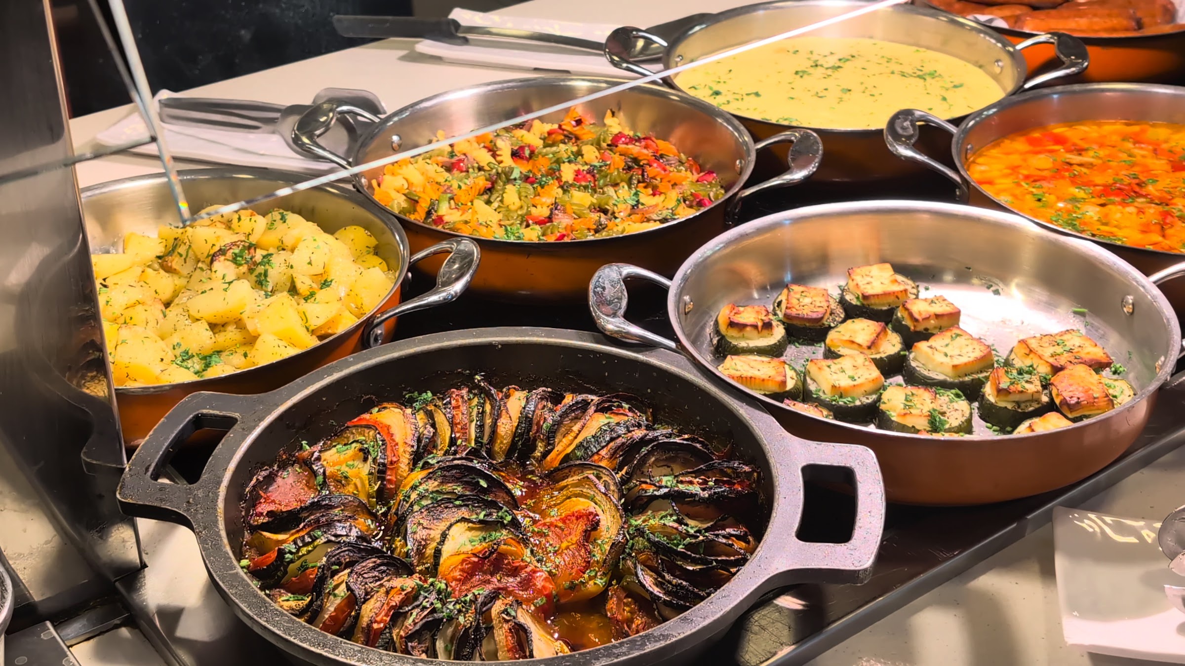 Verduras asadas, patatas y calabacín gratinado en cazuelas del buffet del Magic Robin Hood
